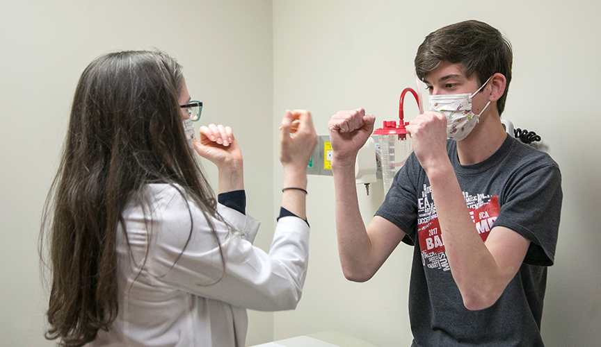 Neurologist examines a patient in Pediatric Stroke Clinic.